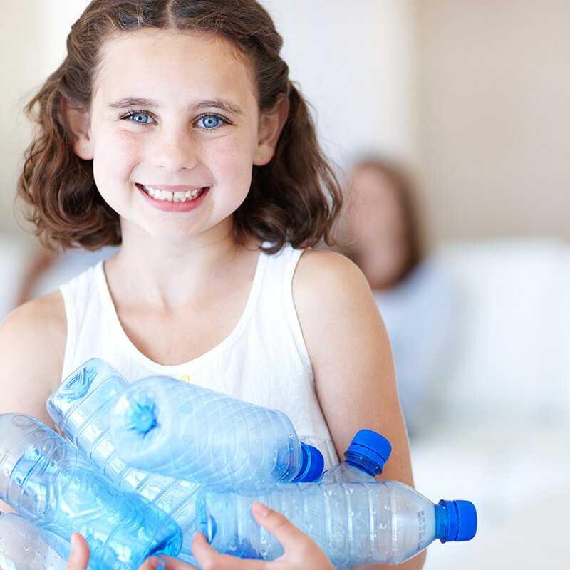 child recycling plastic bottles