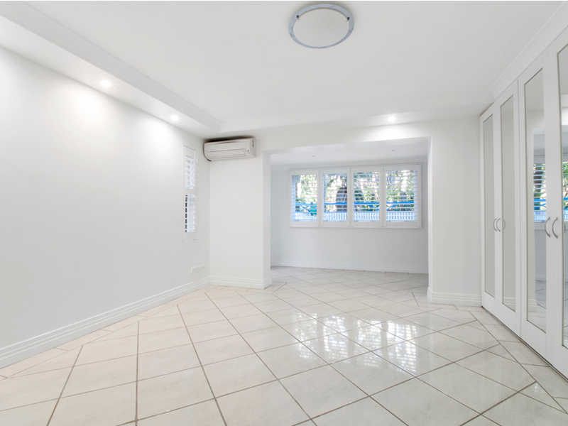 Bright room with large closets and light tile flooring